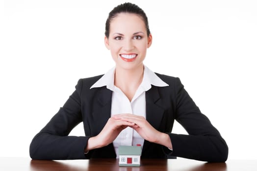 Businesswoman with house model over white - real estate loan or insurance concept