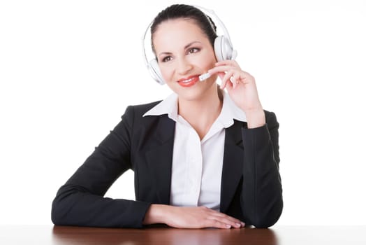 Beautiful young call-center assistant at the desk, isolated on white