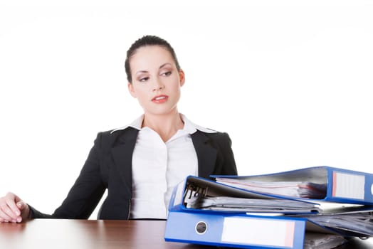 Sad woman with ringbinders sitting at the desk. Tired and exhousted business woman.