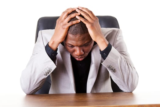 Sad, tired or depressed businessman at the desk.