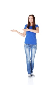 Happy , excited young woman pointing on copy space, isolated on white