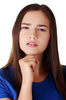 Beautiful girl is standing and wondering. Isolated on the white background.