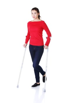 Woman walking with crutches becouse of leg injury