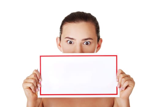Shocked woman holding blank board, isolated on white