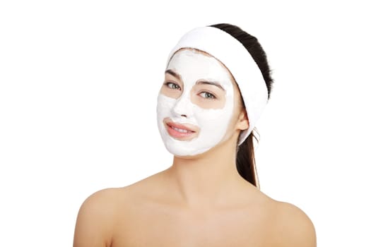 Beautiful woman with clay facial mask, isolated on white