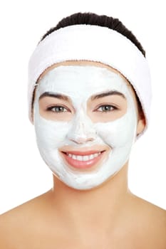 Beautiful woman with clay facial mask, isolated on white