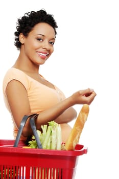 Pregnant woman with shopping basket, isolated on white