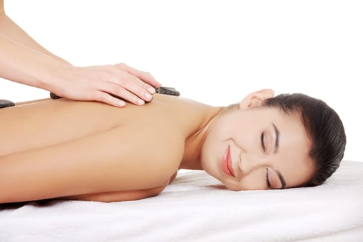 Beauty woman relaxing in spa. Stone massage.