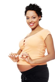 Pregnant woman breaking a cigarette - stop smoking concept
