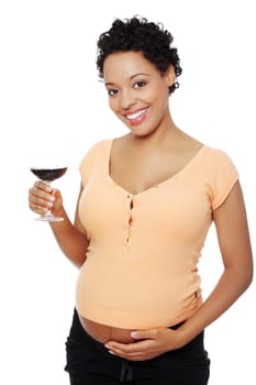 Pregnant woman holding glass of alcohol ( wine ), isolated on white