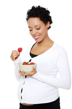 Portrait of a beautifyl young woman eating strawberries, isolated on a white background.