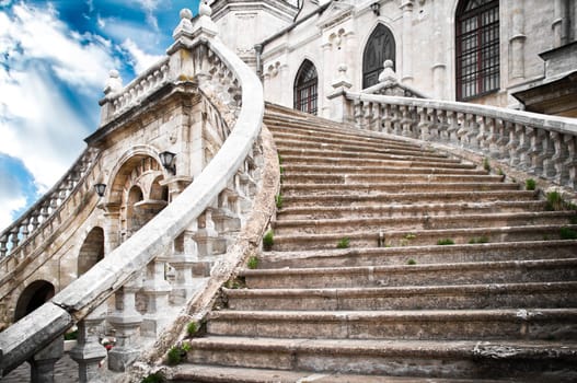 Beautiful ancient grand stairway of the church with blue cloudy sky in background (Bykovo, Russia)