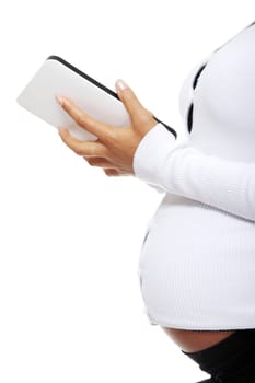 Pregnant woman relaxing with a computer tablet , isolated on white