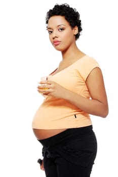 Pregnant woman holding a glass of alcohol next to her tummy, isolated on white background.