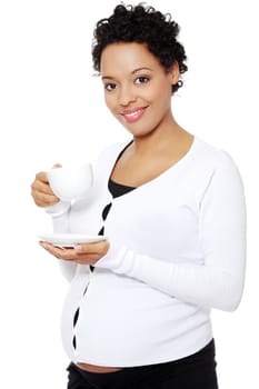 Young pretty pregnant woman drinks cafe or tea