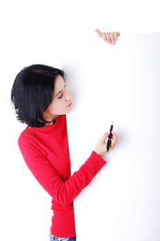 Happy beautiful woman writing with a pen on blank board. Student or businesswoman.