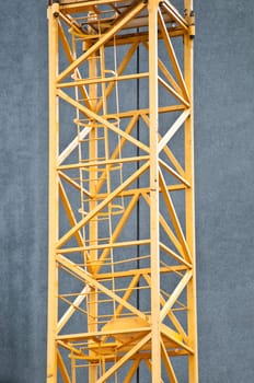 abstract of construction crane boom (and small gull on in) with blue sky in background