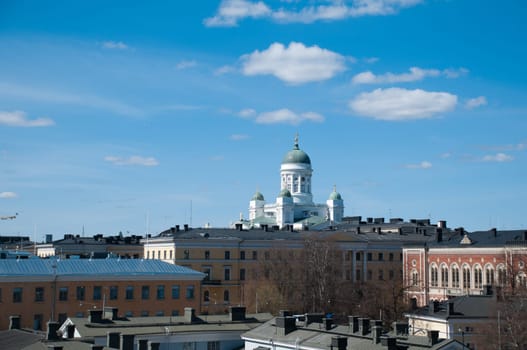view of Helsinki roofs and cathedral with blue cloudy sky in background