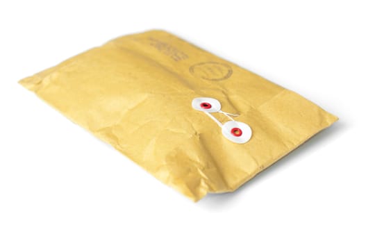 closed yellow mail parcel isolated on white background