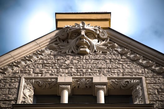 spooky old house roof top with demon head (Riga, Latvia, Europe)
