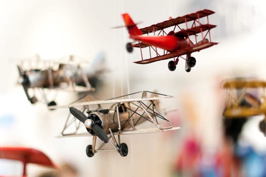 three old style toy planes with focus on first plane propeller, extremely shallow depth of filed