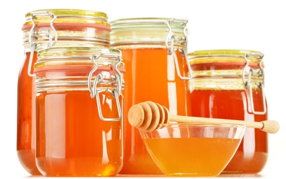 Composition with jars of honey isolated on white background