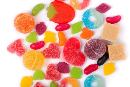 An assortment of colorful candy on background with jellybeans, gumdrops and other jelly candies