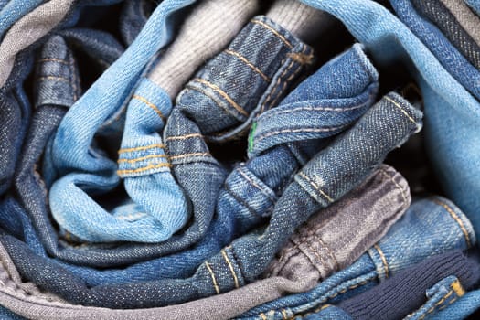 stack of various jeans, background