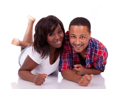 Happy young black African American couple lying down on the floor, isolated on white background - african people