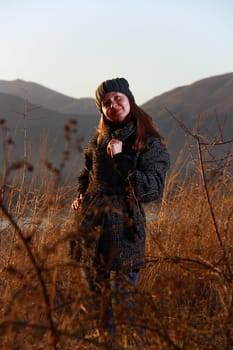 girl walking in bushes when sun going down
