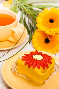 tea with cake and gerberas flowers