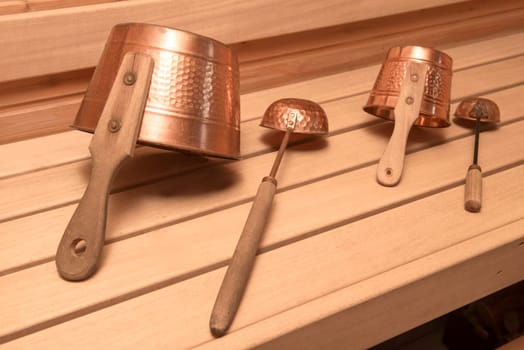 Two buckets for water with ladles in an interior of the Finnish sauna