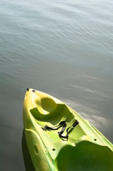 Detail of a plastic kayak standing in the water