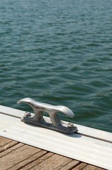 Detail of a wooden floating dock with mooring bitts