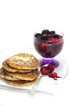 Homemade rice pudding pancakes with powdered sugar and fruity berry groats according to a traditional recipe