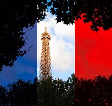 View of top of eiffel tower at sunset. Blue sky with clouds in background. Dark trees in foreground. French flag overlay. Paris, France, Europe.