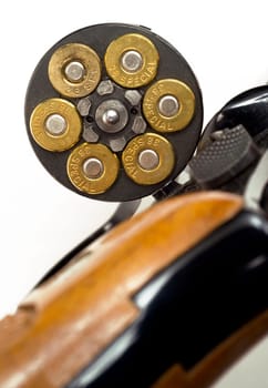 A revolver chamber is open showing amuunition