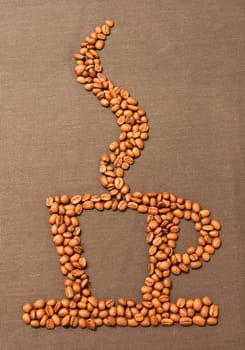 photo of the coffee cup made of the coffee beans on fabric background
