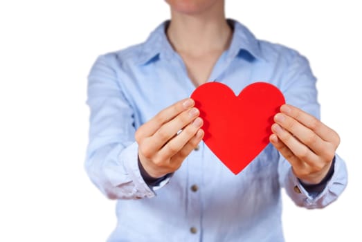 a person with blue shirt holding a heart in its hands