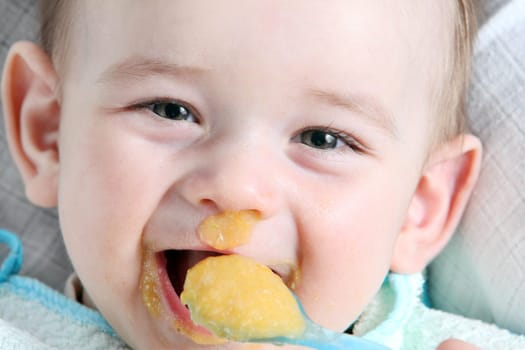 Laughter baby boy eating vegetable mash
