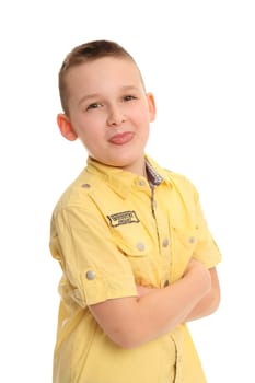 A little boy stands there with his tongue outstretched and looks kindly into the camera.