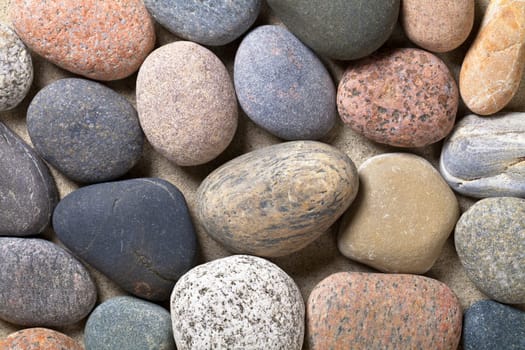 Pebble stones on sand for background. Macro shot. Top view