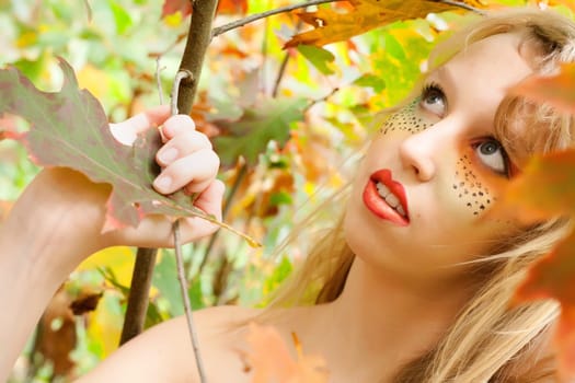 Happy teenager in a forest in the autumn