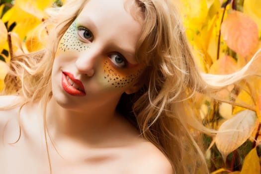 Happy teenager in a forest in the autumn