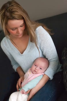 Happy young parents and their little baby