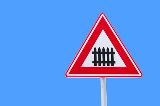 isolated traffic sign approaching a railroad secured with automatic gate