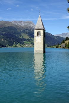 Church tower in Lake Reschen. South tyrol
