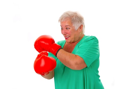 Senior woman with red boxing gloves isolated on white background