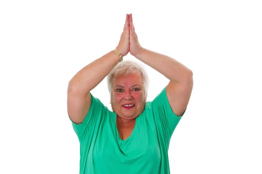 Senior woman doing yoga exercise - isolated on white background