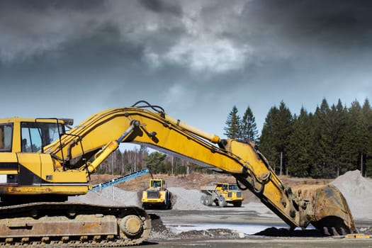 giant bulldozers and diggers in action inside building site